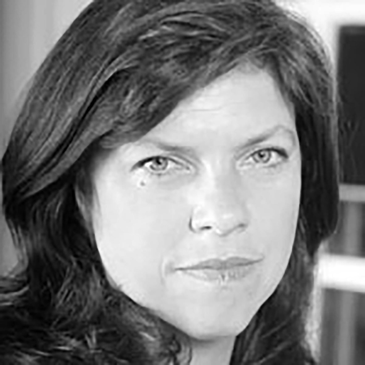 A black and white portrait of a woman with shoulder-length dark hair, looking directly at the camera with a neutral expression.