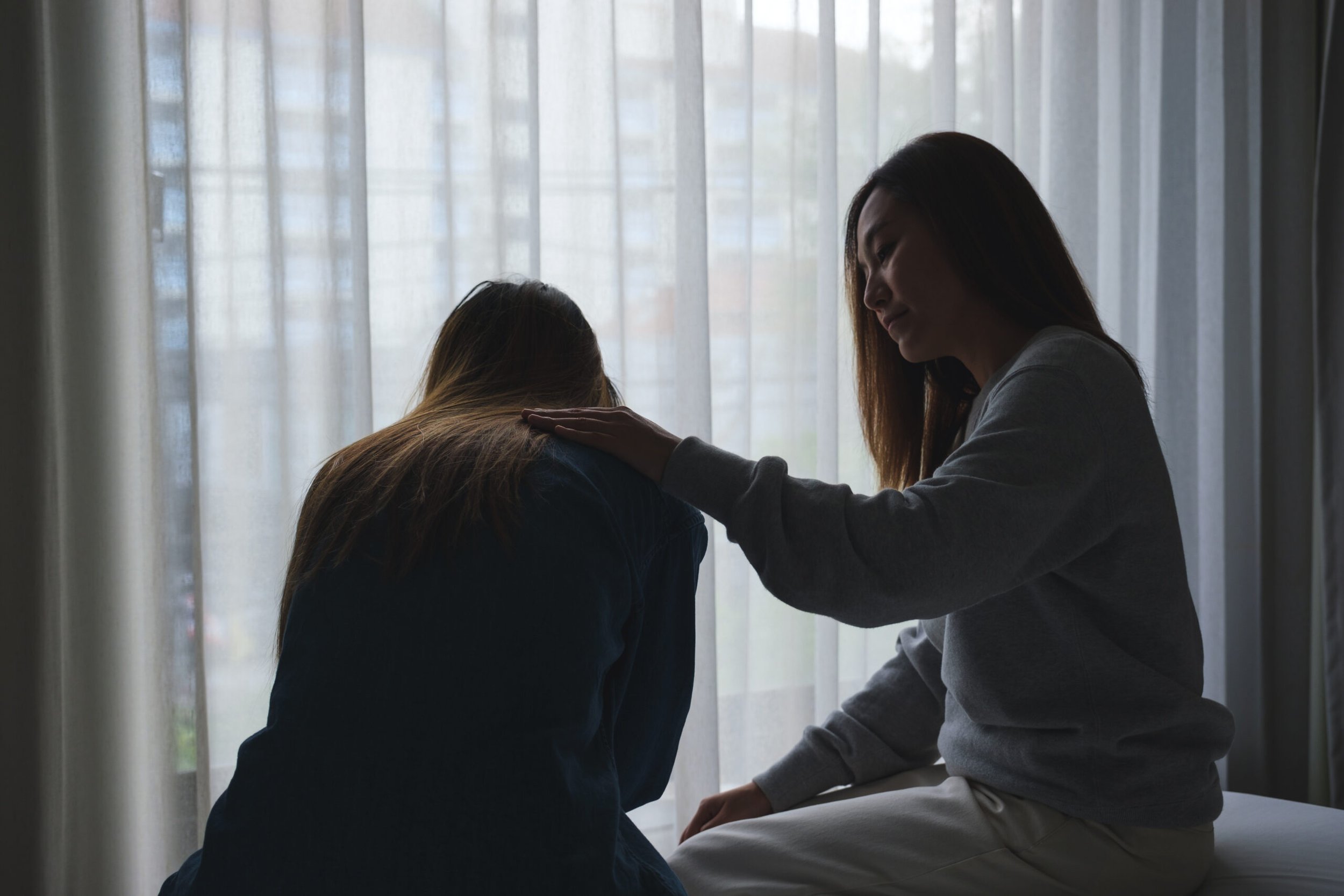 Mother comforting daughter
