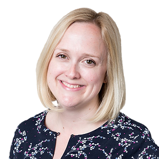 A woman with blonde hair smiling, wearing a dark floral blouse.